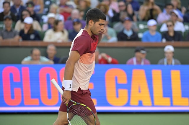 Mar 15, 2025; Indian Wells, CA, USA;  Carlos Alcaraz (ESP) walks back to the baseline after he missed and shot as he was defeated by Jack Draper (not pictured) in three sets during his semifinal match at the BNP Paribas Open at the Indian Well Tennis Garden. Mandatory Credit: Jayne Kamin-Oncea-Imagn Images