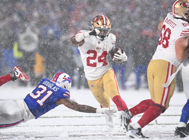 Dec 1, 2024; Orchard Park, New York, USA; San Francisco 49ers running back Jordan Mason (24) avoids a tackle by Buffalo Bills cornerback Rasul Douglas (31) in the third quarter at Highmark Stadium. Mandatory Credit: Mark Konezny-Imagn Images/File Photo
