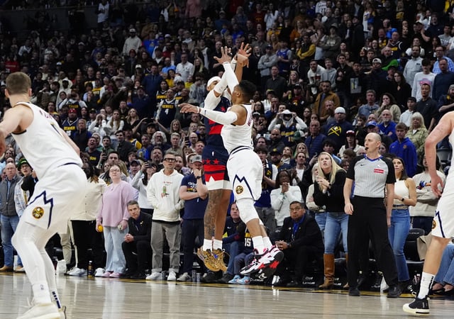 Mar 15, 2025; Denver, Colorado, USA; Washington Wizards guard Jordan Poole (13) shoots over Denver Nuggets guard Russell Westbrook (4) in the fourth quarter at Ball Arena. Mandatory Credit: Ron Chenoy-Imagn Images