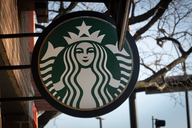 A sign hangs outside of a Starbucks coffeeshop on February 25, 2025 in Chicago, Illinois.