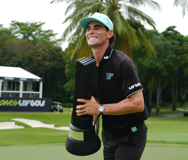 SINGAPORE, SINGAPORE - MARCH 16: Joaquin Niemann of Torque celebrates holds up the LIV trophy on the 9th green after winning the LIV Golf on day three of LIV Golf Singapore at Sentosa Golf Club on March 16, 2025 in Singapore, Singapore. (Photo by Thananuwat Srirasant/Getty Images)