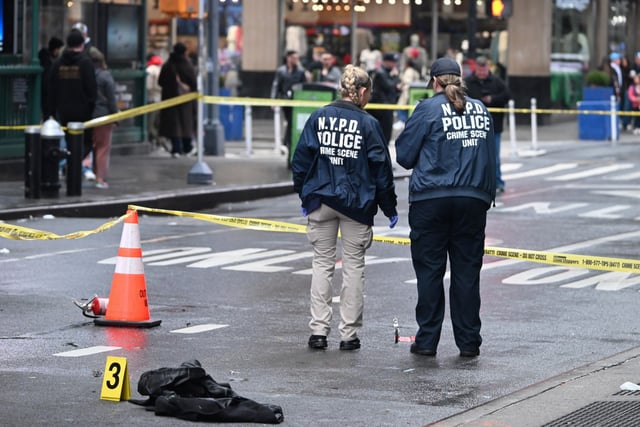Members of the NYPD Crime Scene Unit investigate the scene where a man was set on fire in the heart of Times Square on March 16, 2025.