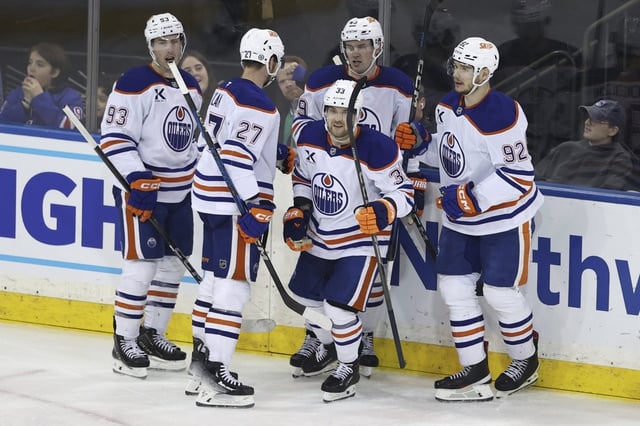 From left, Edmonton Oilers' Ryan Nugent-Hopkins, Brett Kulak, Viktor Arvidsson, Ty Emberson and Vasily Podkolzin react after Arvidsson scored during the third period of an NHL hockey game against the New York Rangers Sunday, March 16, 2025, in New York. (AP Photo/Pamela Smith)