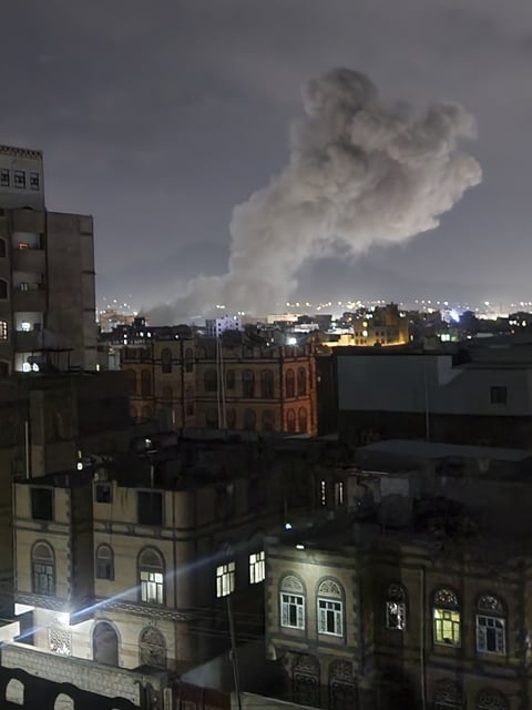 Smoke rises from a location reportedly struck by U.S. airstrikes in Sanaa, Yemen, Saturday, March 15, 2025. (AP Photo/Osamah Abdulrahman)