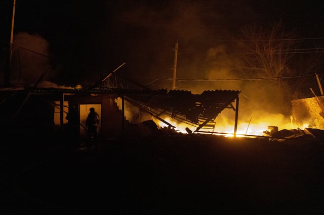 Firefighters extinguish a fire on a damaged building following a strike in Kramatorsk, Donetsk region on March 11, 2025.