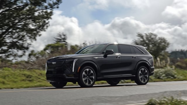 A black Cadillac Escalade IQ by the side of the road