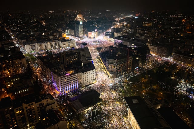 This aerial photograph shows protesters holding up their mobile phones to light up the night sky in memory of those who died in the Novi Sad roof disaster, as they take part in one of the largest anti-corruption demonstrations, in Belgrade on March 15, 2025.