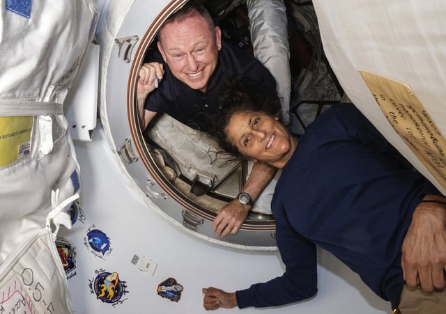 Astronauts Butch Wilmore and Suni Williams pose inside the vestibule between the forward port on the International Space Station's Harmony module and Boeing's Starliner spacecraft on June 13, 2024. 