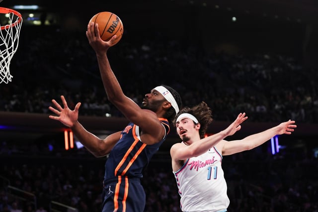 New York Knicks forward Precious Achiuwa, left, drives to the basket past Miami Heat guard Jaime Jaquez Jr. (11) during the first half of an NBA basketball game, Monday, March 17, 2025, in New York. (AP Photo/Heather Khalifa)