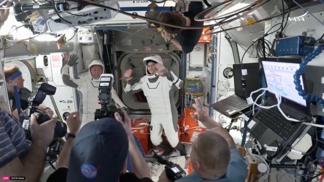 Butch Wilmore and Suni Williams, two veteran NASA astronauts who have been stuck on the International Space Station for nine months, wave at the hatch of a SpaceX Crew Dragon capsule before closing the hatch in preparation for undocking from the ISS to begin their return to Earth March 17, 2025 in this still image taken from video.   NASA/Handout via REUTERS