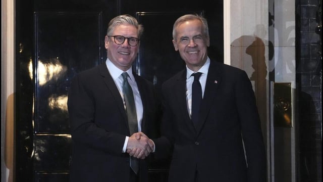 Canada Prime Minister Mark Carney (right) is greeted by British Prime Minister Keir Starmer in London on Monday. (AP)
