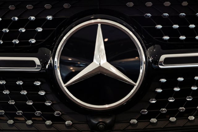A logo of Mercedes-Benz is seen inside a Mercedes-Benz car dealer in Arnhem, Netherlands February 18, 2025. REUTERS/Piroschka van de Wouw/File Photo