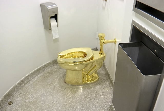 FILE - This screenshot made from a video shows the 18-karat toilet, titled "America," by Maurizio Cattelan in the restroom of the Solomon R. Guggenheim Museum in New York, Sept. 16, 2016. (AP Photo, File)