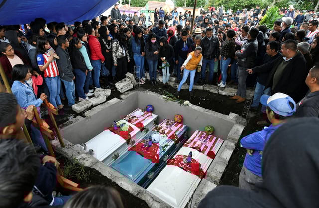 Relatives and friends of late migrants Jair Valencia, 19, Yovani Valencia, 16, and Misael Olivares, 16, attend the funeral, after their death last month when they suffocated while being smuggled in a trailer in San Antonio, Texas, U.S., at a cemetery in the town of San Marcos Atexquilapan, in Veracruz state, Mexico July 15, 2022. REUTERS/Yahir Ceballos/File Photo