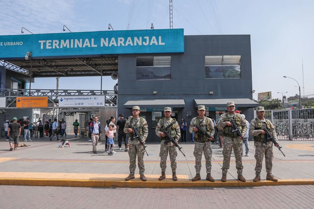 Military forces stand guard outside the Naranjal Metropolitano transport station in Lima on March 18, 2025, a day after Peru declared a month-long state of emergency in the capital after a wave of killings linked to extortion.