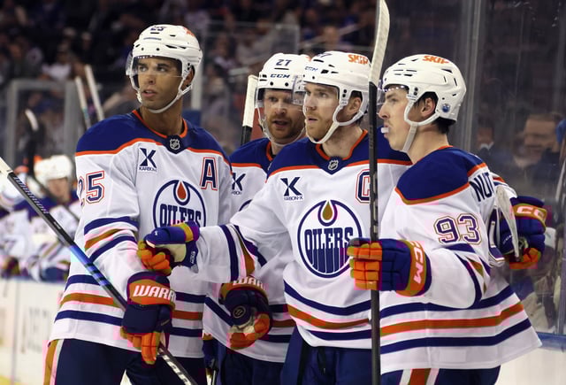 Connor McDavid #97 of the Edmonton Oilers (2nd from right) celebrates his empty-net goal against the New York Rangers at Madison Square Garden on March 16, 2025 in New York City. The Oilers defeated the Rangers 3-1.