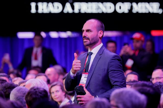 Eduardo Bolsonaro, a member of Brazil's National Congress and a son of former Brazilian President Jair Bolsonaro, gestures in the audience as U.S. President Donald Trump addresses the Conservative Political Action Conference (CPAC) annual meeting in National Harbor, Maryland, U.S., February 22, 2025. REUTERS/Brian Snyder/File Photo