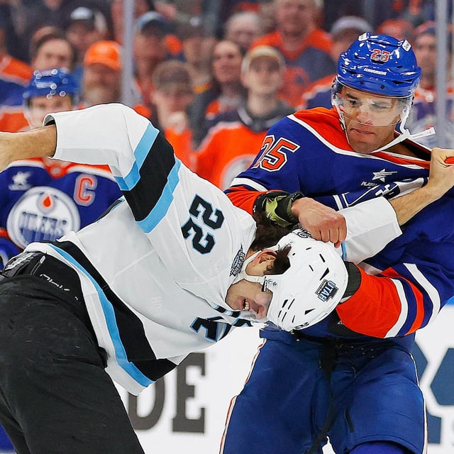 Mar 18, 2025; Edmonton, Alberta, CAN; Edmonton Oilers defensemen Darnell Nurse (25) and Utah Hockey Club forward Jack McBain (22) fight during the first period at Rogers Place. Mandatory Credit: Perry Nelson-Imagn Images