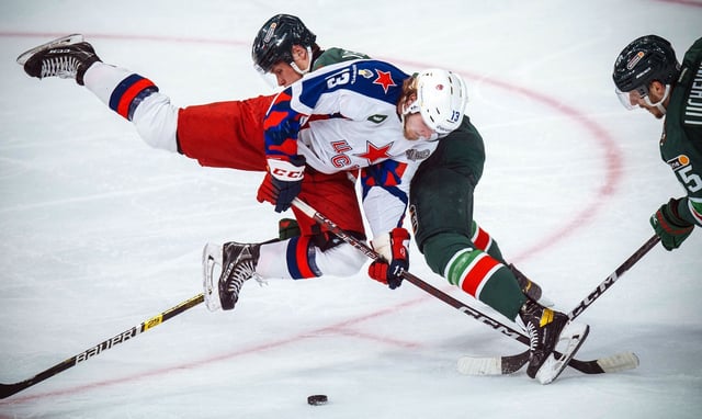 CSKA Moscow&#39;s Prokhor Poltapov (L) fights for the puck with Nikita Yevseyev (C) and Konstantin Luchevnikov (R) of Ak Bars Kazan during the Gagarin Cup 2023 final series game of the Russian Kontinental Hockey League (KHL).
