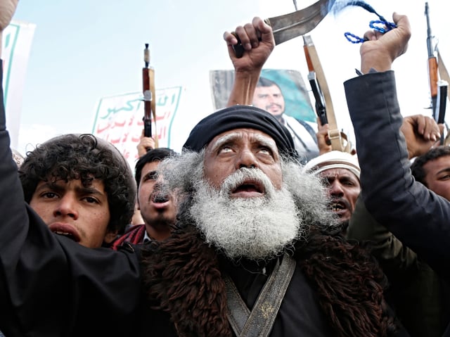 ANA'A, YEMEN - MARCH 17: Yemenis including Houthi group loyalists brandish their rifles and daggers, and chant slogans as they partake in a demonstration staged against the United States' aerial attacks on the capital Sana'a, and other provinces on March 17, 2025 in Sana'a, Yemen. Yemen's Iran-backed Houthis have declared that during the past 24 hours, they launched two missile-drone attacks on the American aircraft carrier group as retaliation for deadly US strikes targeting several of Yemen's Houth-held territories that left at least 53 people killed and more than 100 others injured, among them five children and two women. (Photo by Mohammed Hamoud/Getty Images)