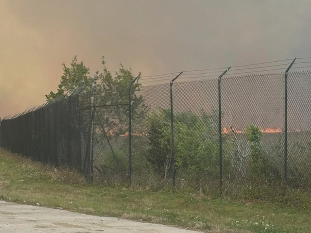 Smoke from wildfire fills the sky on Card Sound Road heading to the Florida Keys on Tuesday, March 18, 2025.  (Monroe County Board of County Commissioners via AP)