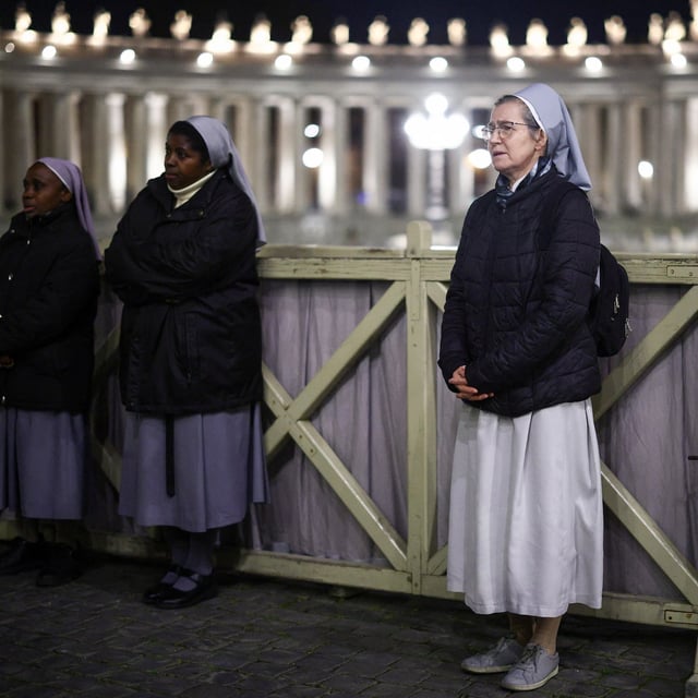 Nuns attend a prayer service in St. Peter's square, as Pope Francis continues hospitalization, at the Vatican, March 19, 2025. REUTERS/Guglielmo Mangiapane