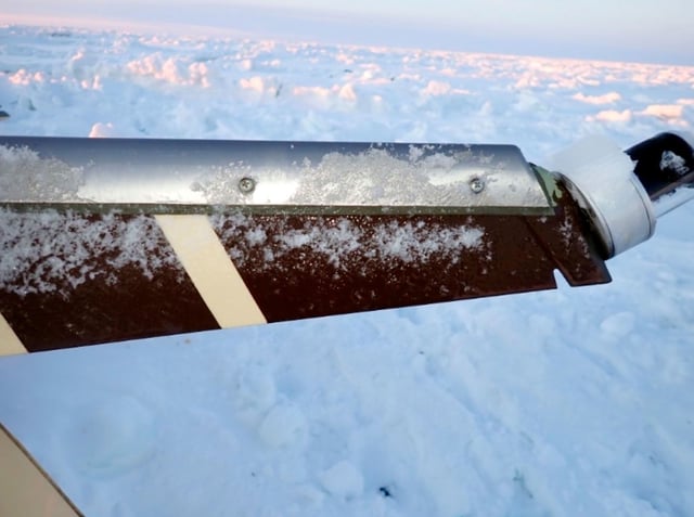 This NTSB image shows ice accumulation seen on the base of the beacon/strobe light located at the top of the vertical stabilizer, February 7, 2025, they day after after the small commuter plane crashed.