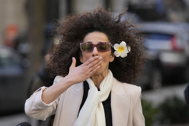 Masih Alinejad blows a kiss to supporters outside the federal courthouse after testifying at the trial of her would-be assassins in New York, Tuesday, March 18, 2025. (AP Photo/Seth Wenig)