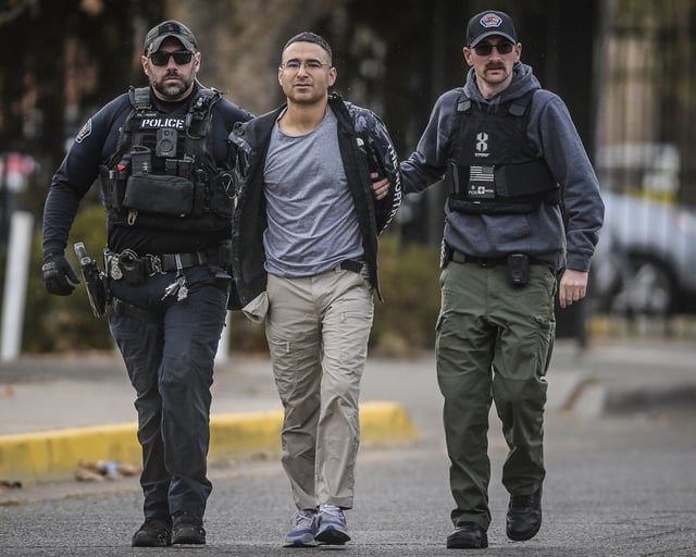 Solomon Peña, center, a failed Republican candidate, is taken into custody by Albuquerque, New Mexico, Police officers on January 16, 2023, in southwest Albuquerque.