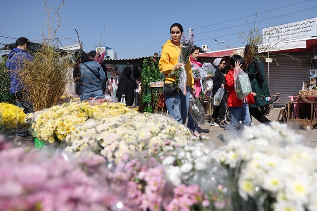 Iranian people shop at a flower market ahead of Nowruz, the Iranian New Year, in Tehran, Iran March 17, 2025. Majid Asgaripour/WANA (West Asia News Agency) via REUTERS ATTENTION EDITORS - THIS PICTURE WAS PROVIDED BY A THIRD PARTY