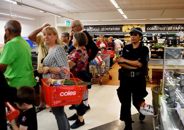 Police supervise as locals shop for supplies for at a supermarket which has power in Batemans Bay, NSW, Australia January 5, 2020. REUTERS/Tracey Nearmy/File Photo