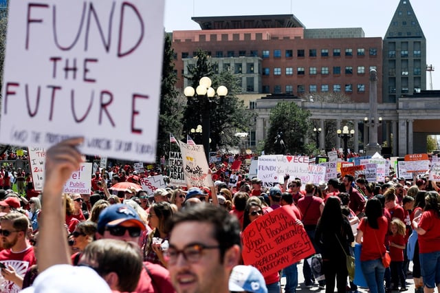 Teachers wear red as thousands march during a teachers rally for more educational funding at the Colorado State Capitol on Friday, April 27, 2018. Thousands of Colorado teachers showed up at the capitol to demonstrate the need for increased funding. The Colorado Education Association said the walkouts are necessary to alert residents and lawmakers about the status of school funding in Colorado. The stateÕs schools are currently underfunded by $822 million and are $2,700 below the national average in per-pupil funding, the CEA said.