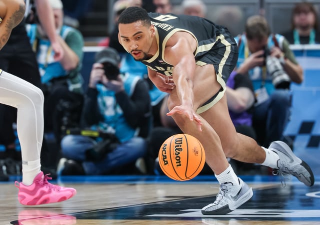 Trey Kaufman-Renn #4 of the Purdue Boilermakers reaches for the ball during the game against the Michigan Wolverines in the Big Ten men&#39;s basketball tournament quarterfinals at Gainbridge Fieldhouse on March 14, 2025 in Indianapolis, Indiana.