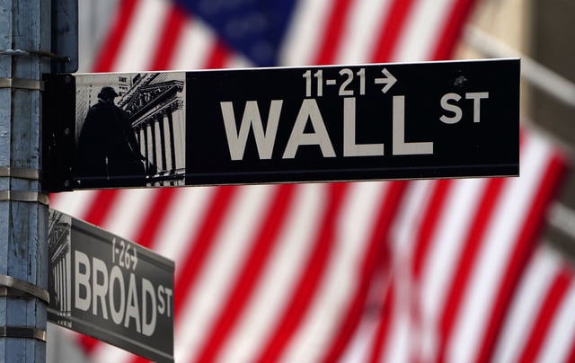 A Wall Street sign is pictured outside the New York Stock Exchange in the Manhattan borough of New York City, New York, U.S., April 16, 2021. REUTERS/Carlo Allegri/File Photo