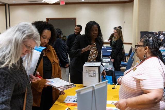 Paulette Phillips speaks with Nancy McNealy of KansasWorks during a job fair for federal workers fired in recent weeks through job cuts, organized by the National Treasury Employees Union (NTEU) in Kansas City, Missouri, U.S. March 15, 2025. Phillips is currently a federal employee working at the IRS, she's at the job fair to research backup employment opportunities in the event she is fired.