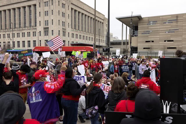Federal workers and allies hold signs as they listen to a speech during a rally across the street from the Internal Revenue Service (IRS) headquarters, in support of the civil service in the wake of mass firings, and organized by the National Treasury Employees Union (NTEU) in Kansas City, Missouri, U.S. March 15, 2025.