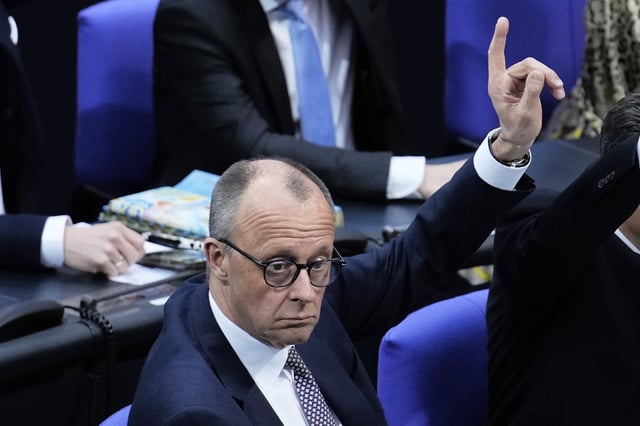 German opposition leader and Christian Democratic Union party chairman Friedrich Merz attends a debate and voting about loosen the country's debt rules and change constitution in the German Parliament Bundestag in Berlin, Germany, Tuesday, March 18, 2025. (AP Photo/Ebrahim Noroozi)