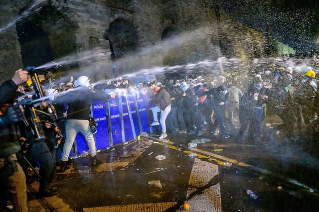 Protesters react to tear gas sprays as they clash with riot police during a demonstration following the arrest of Istanbul's mayor, near the city hall of Istanbul, on March 21, 2025 (Photo by Yasin AKGUL / AFP) (Photo by YASIN AKGUL/AFP via Getty Images)