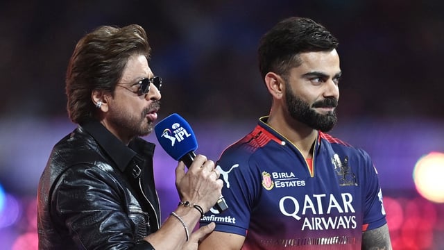 Royal Challengers Bangalore's Virat Kohli with Shah Rukh Khan before the match. REUTERS/Abhijit Addya