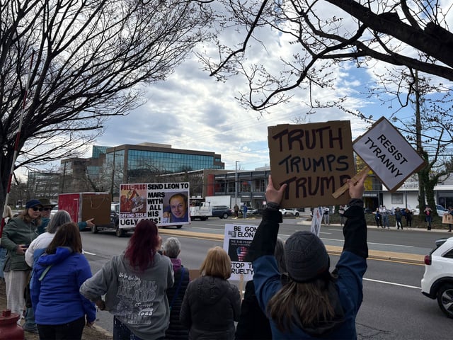 Demonstrators rally outside a Tesla showroom in Rockville, Maryland, on Saturday, March 22, 2025.