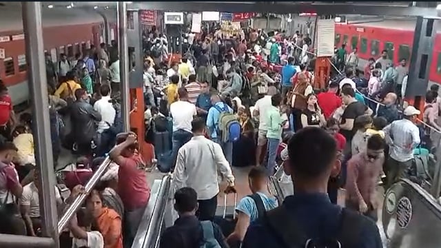 Commuters were seen scaling barricades and jumping queues, though the exact time of the surge remains unclear.