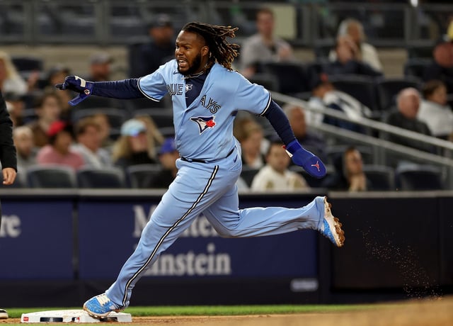 NEW YORK, NEW YORK - APRIL 21: Vladimir Guerrero Jr. #27 of the Toronto Blue Jays rounds third and scores off a double from teammate Brandon Belt in the eighth inning against the New York Yankees at Yankee Stadium on April 21, 2023 in the Bronx borough of New York City.