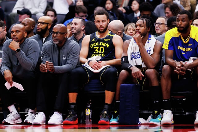 The Golden State Warriors’ Stephen Curry sits on the bench against the Toronto Raptors at Scotiabank Arena on Jan. 13, 2025, in Toronto.