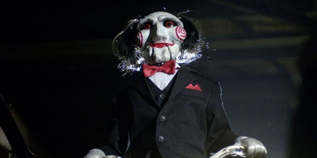 Billy the Puppet centered while on a tricycle. 