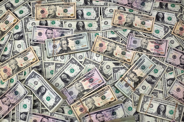 U.S. dollar banknotes are seen in this photo illustration taken February 12, 2018. REUTERS/Jose Luis Gonzalez/Illustration/File Photo