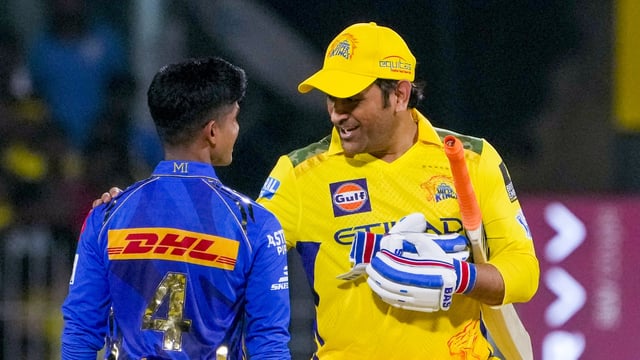Chennai Super Kings' batter MS Dhoni interacts with MI's Vignesh Puthur after CSK's win against Mumbai Indians on Sunday