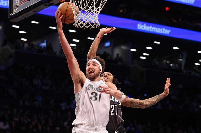 Mar 24, 2025; Brooklyn, New York, USA; Dallas Mavericks guard Klay Thompson (31) goes to the basket against \Brooklyn Nets forward Maxwell Lewis (27) during the second half at Barclays Center. Mandatory Credit: Vincent Carchietta-Imagn Images
