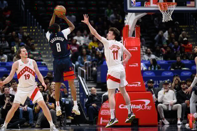 Mar 24, 2025; Washington, District of Columbia, USA; Washington Wizards guard Bub Carrington (8) takes a shot over Toronto Raptors center Colin Castleton (11) during the third quarter  at Capital One Arena. Mandatory Credit: Reggie Hildred-Imagn Images