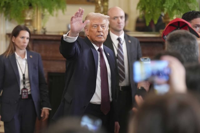 President Donald Trump waves as he departs a reception celebrating Greek Independence Day in the East Room of the White House on Monday.