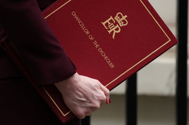 British Chancellor of the Exchequer Rachel Reeves carries a folder as she walks in Downing Street ahead of presenting the Spring Statement to Parliament, in London, Britain, March 26, 2025. REUTERS/Hannah McKay